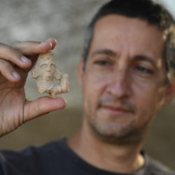 מנהל החפירה, איתי אביב, מחזיק צלמית אדם בת כ-1600 שנה. צילום: יולי שוורץ