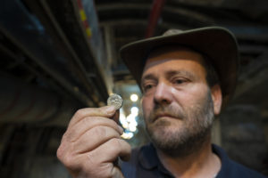 מנהל החפירה, ארי לוי, מחזיק את המטבע הנדיר. צילום, יניב ברמן